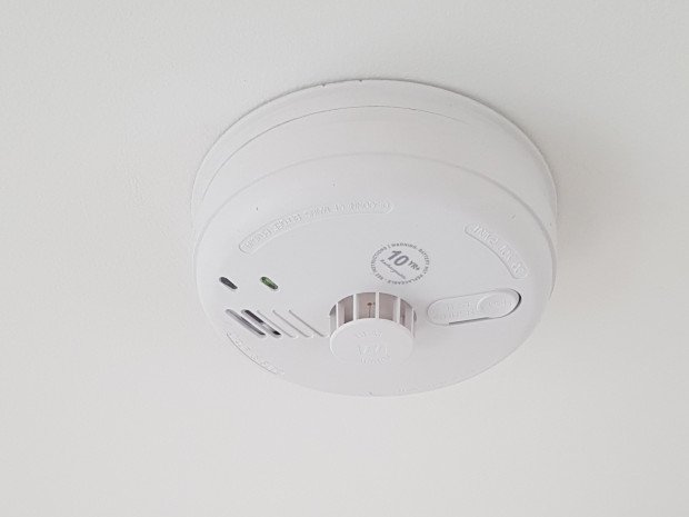 white smoke alarm on ceiling