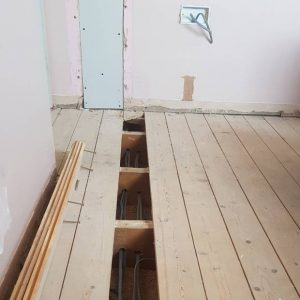 floorboards lifted with cables installed during electrical rewiring