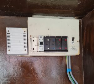 Old electric fusebox made by Wylex on wooded board