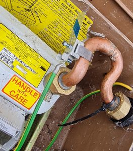 electrical cable clamped to gas meter as required by BS7671