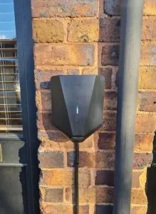 Easee One EV charge point installed on brick wall