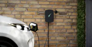 Black Hypevolt 3 EV charger on Brick wall plugged into Renaul Zoe